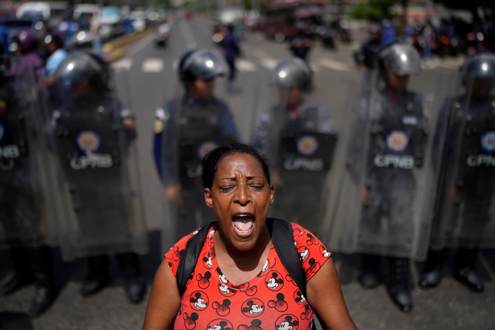 La policía bloquea el paso de un familiar de un preso en huelga de hambre para que la manifestación de su grupo no bloquee todos los carriles de la avenida Bolívar en Caracas, Venezuela, el miércoles 12 de junio de 2024. Foto AP